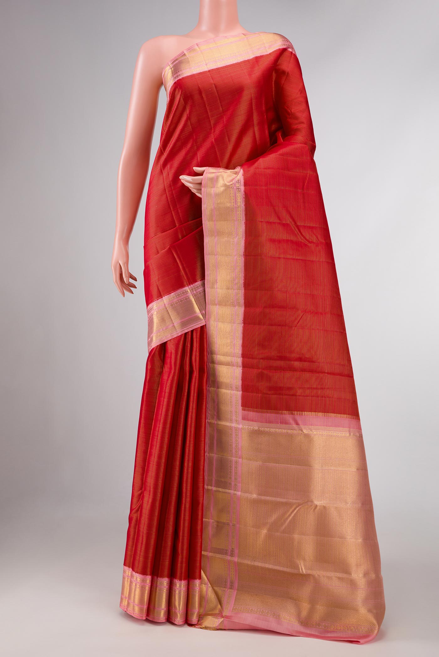 Red Dual Tone Kanchipuram Silk Saree with Stripes on the body and Zari Border displayed on a mannequin