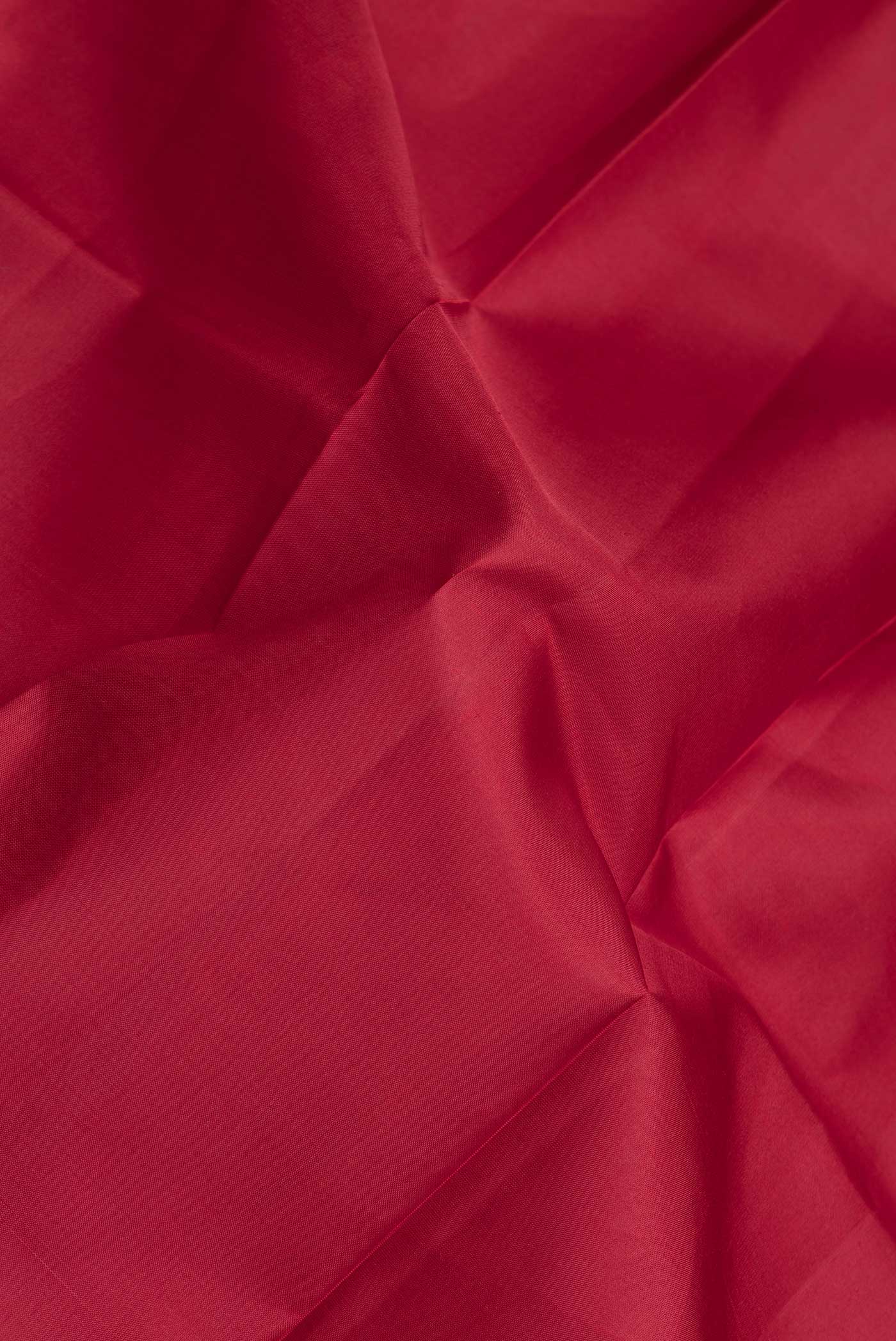 Close up of Maroon Dual Tone Kanjivaram Silk Saree with Plain Body and Zari Border.  displaying folds