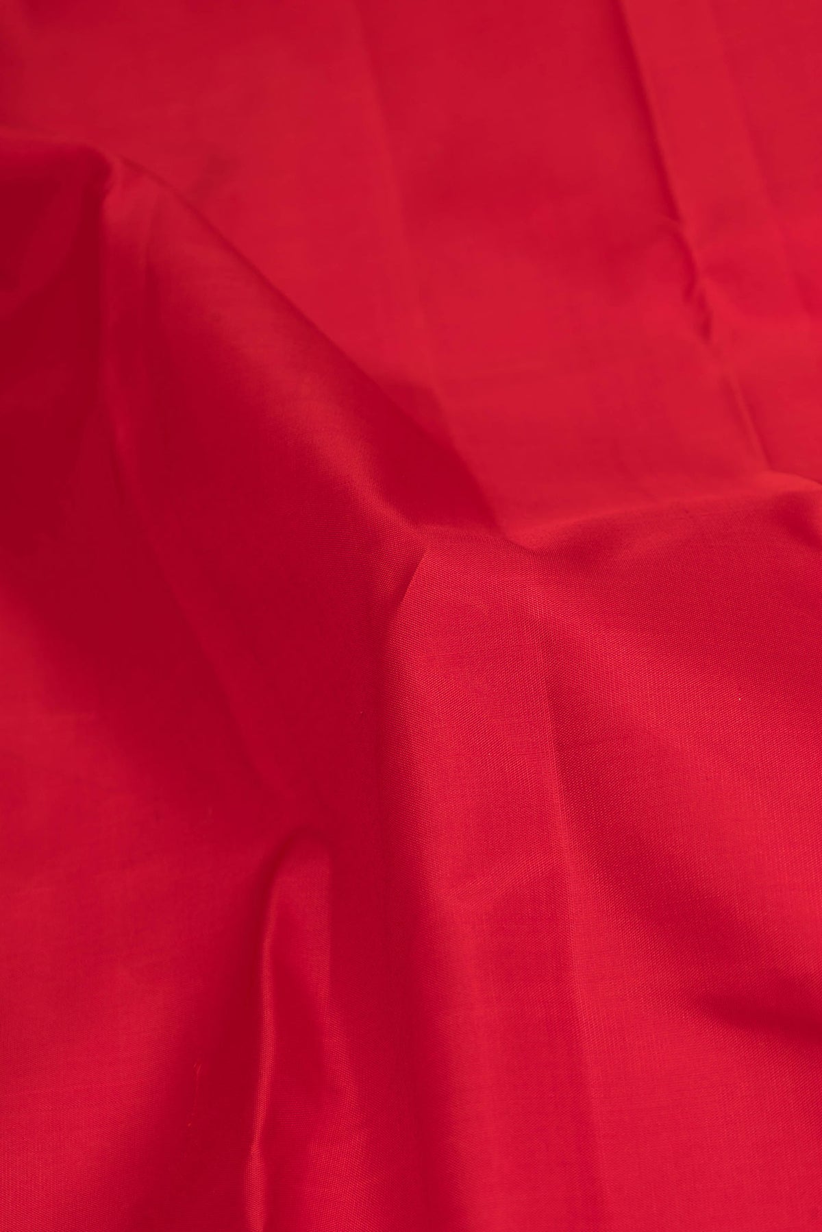 Close up of Red Dual Tone Kanchipuram Silk Saree with Plain Body and Zari Border displaying folds