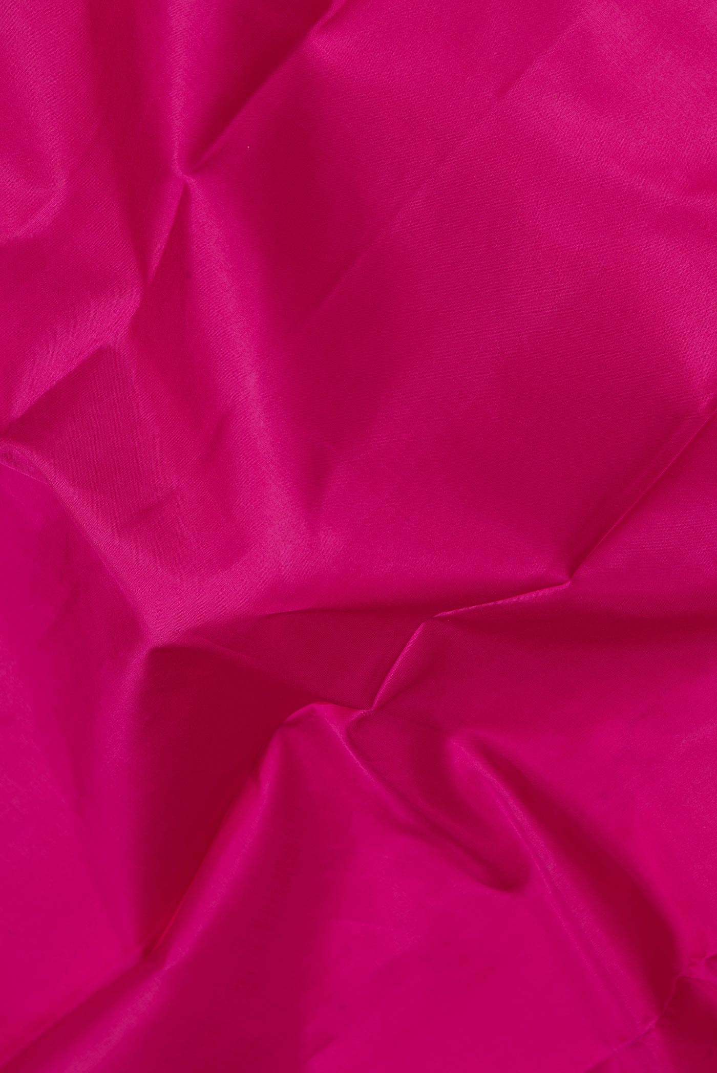 Close up of Pink Dual Tone Kanchipuram Silk Saree with Plain Body and Zari Border.  displaying folds