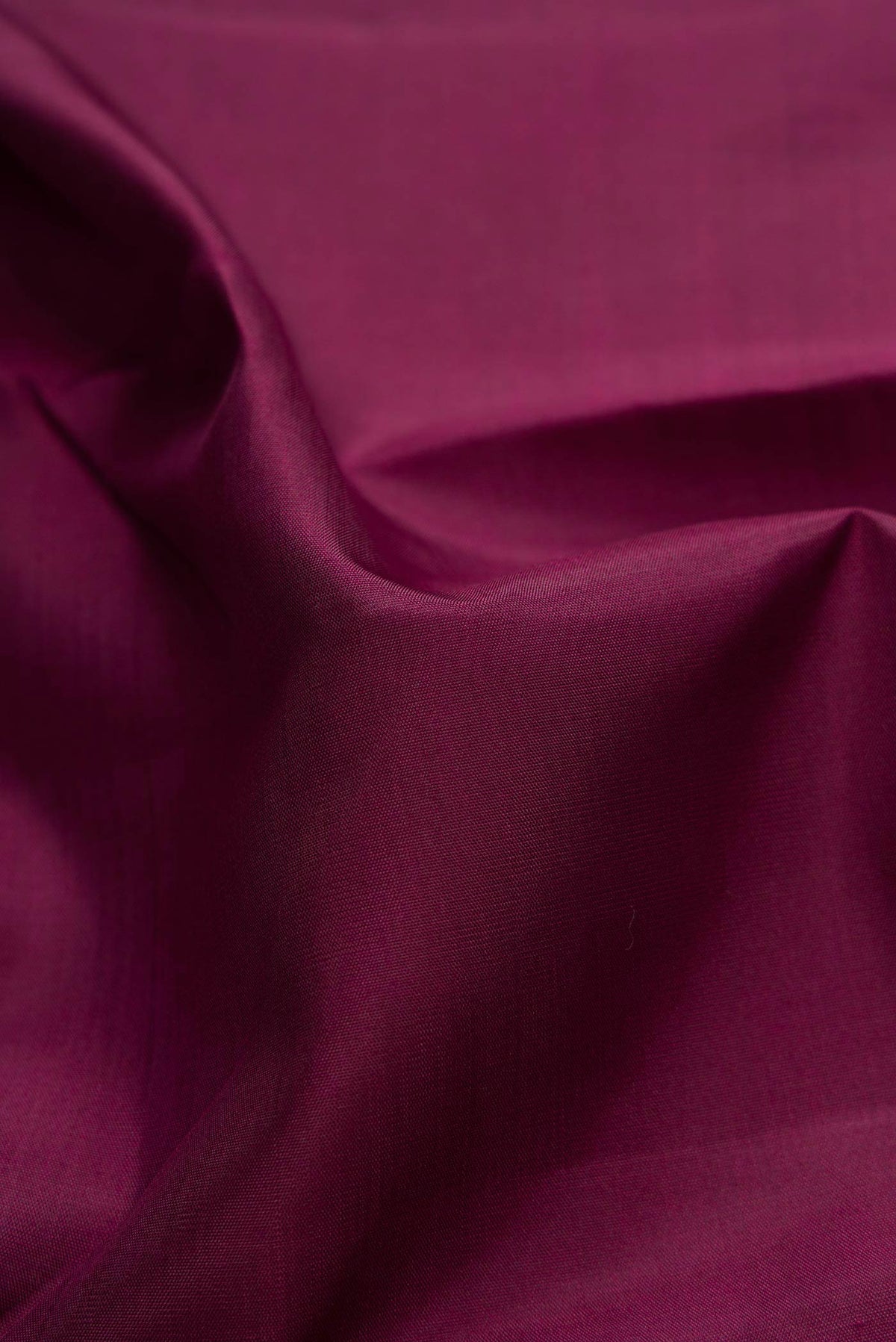 Close up of Pure Silk Pure Zari Maroon Dual Tone Kanchipuram Saree with Plain Body and Zari Border displaying folds
