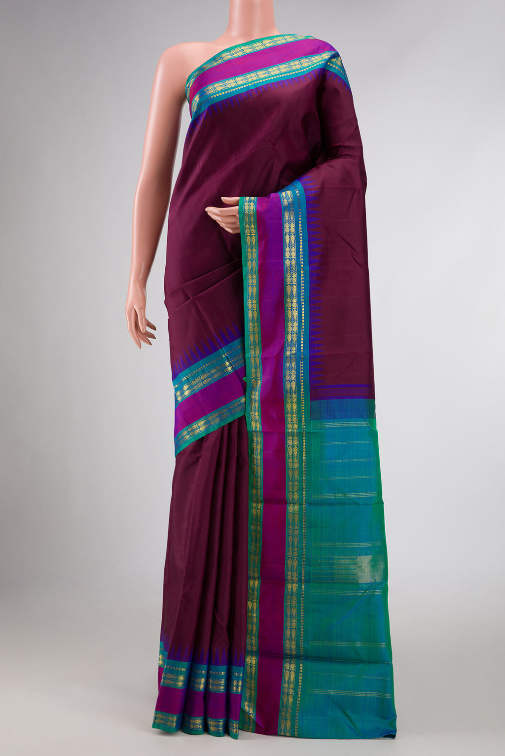 Pure Silk Pure Zari Maroon Dual Tone Kanchipuram Saree with Plain Body and Zari Border displayed on a mannequin
