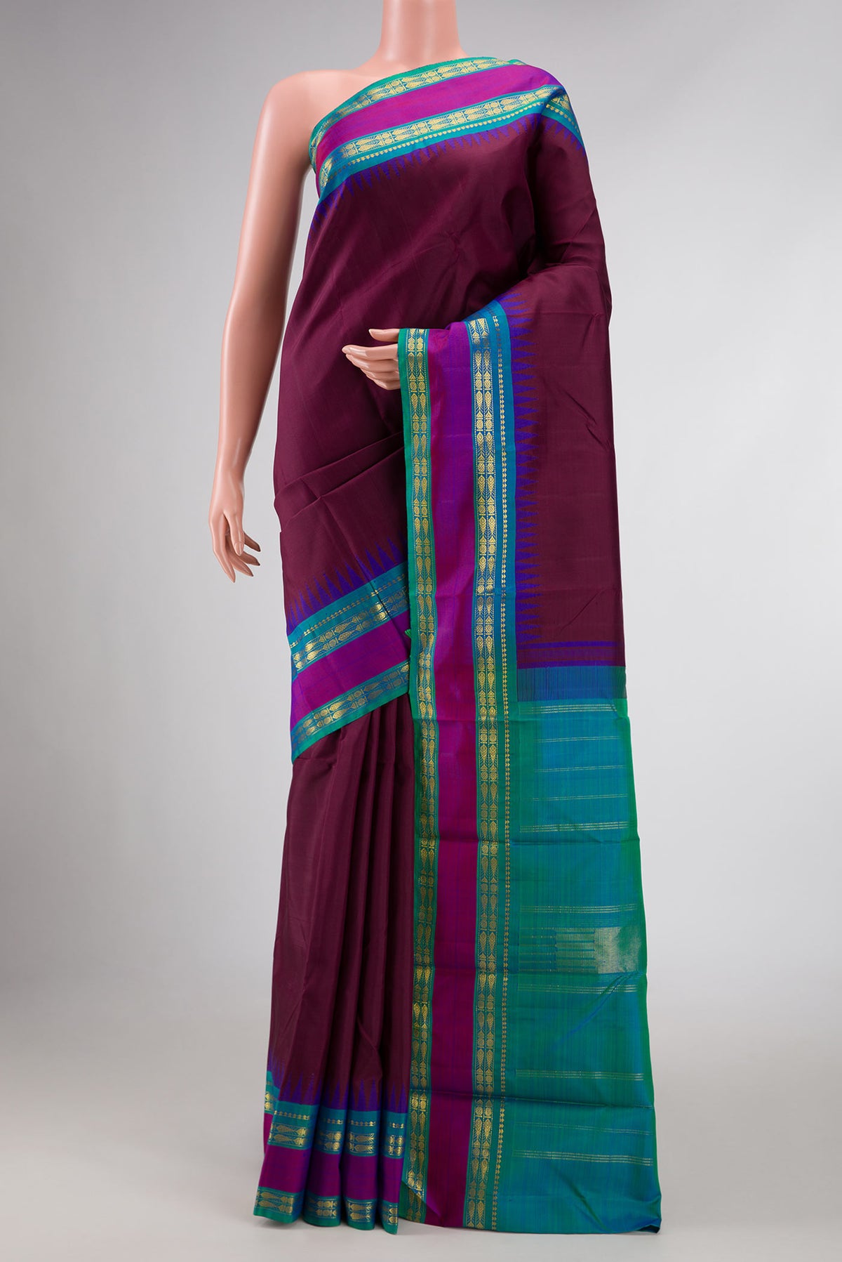 Pure Silk Pure Zari Maroon Dual Tone Kanchipuram Saree with Plain Body and Zari Border displayed on a mannequin