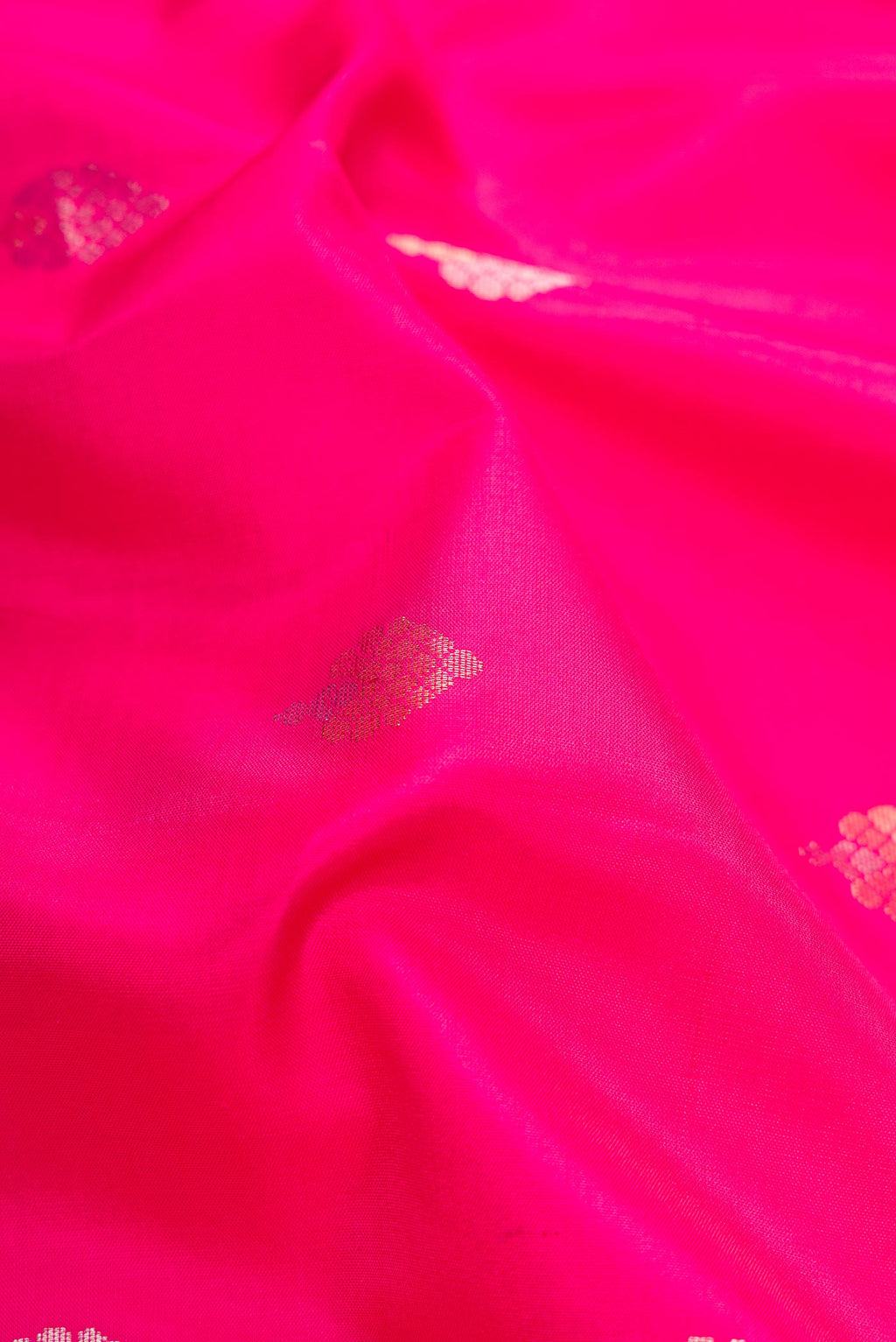 Close up of Pink Dual Tone Soft Silk Saree with Zari Butta on the body and Zari Border.  displaying folds