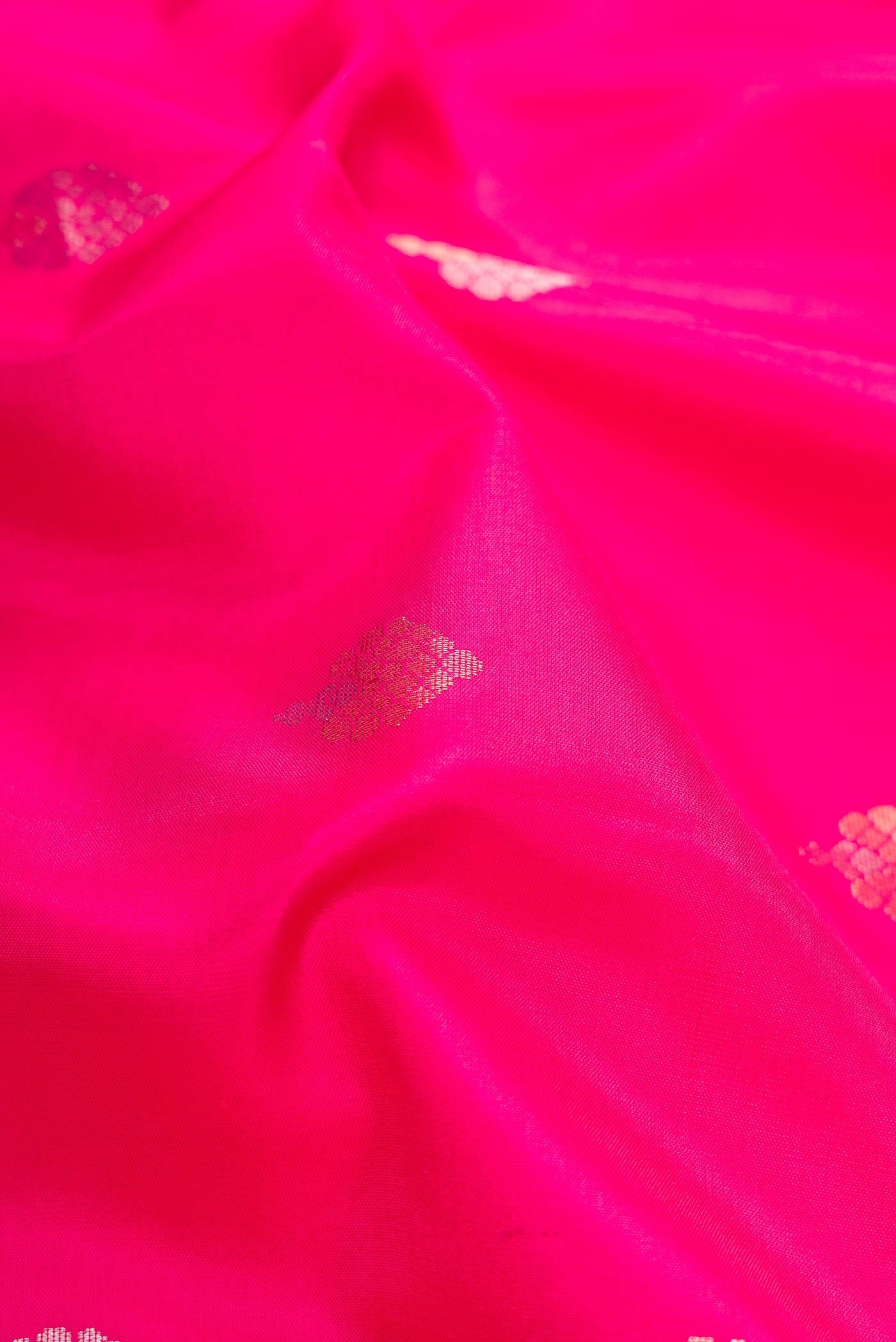 Close up of Pink Dual Tone Soft Silk Saree with Zari Butta on the body and Zari Border.  displaying folds