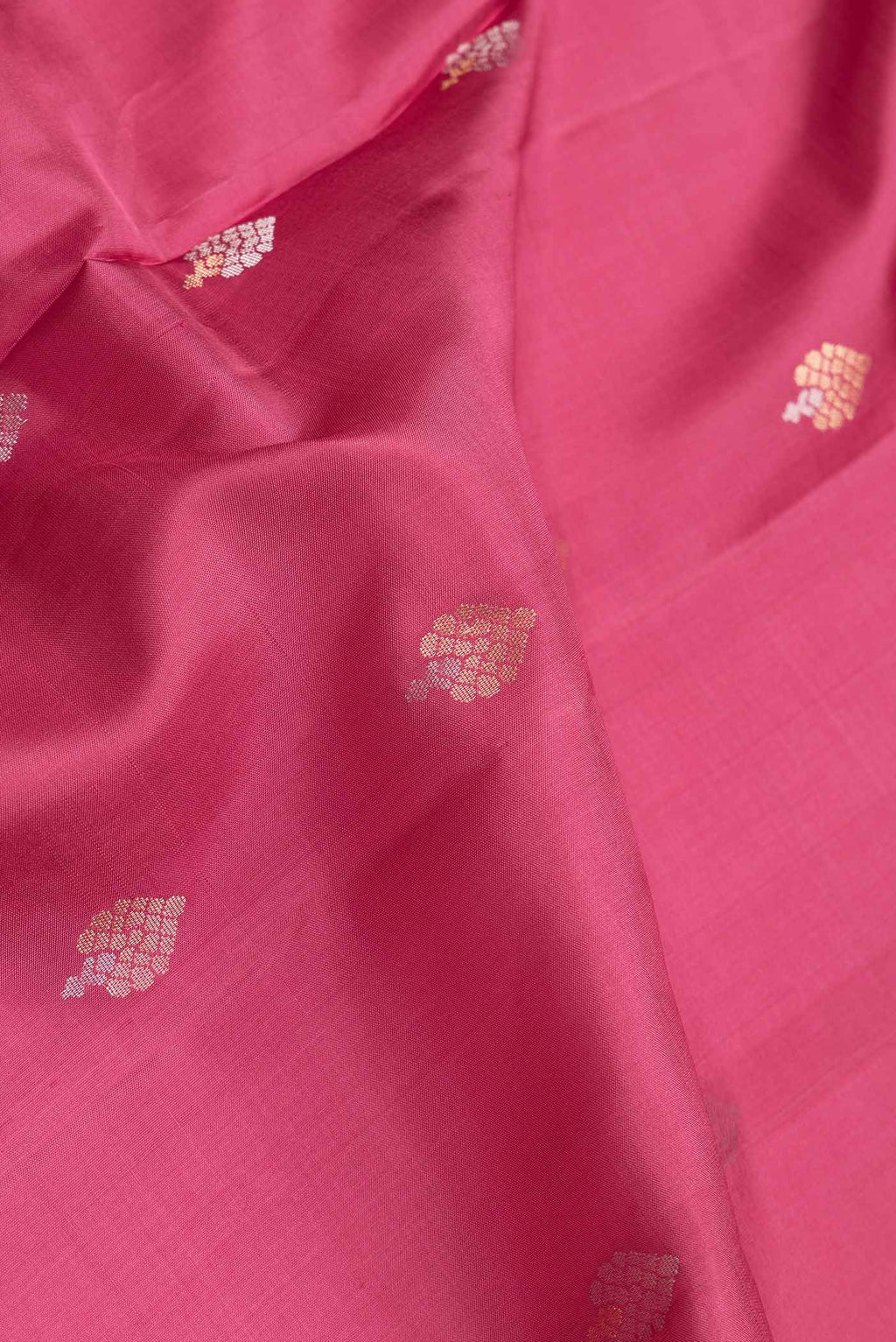 Close up of Dark Pink Dual Tone Soft Silk Saree with Zari Butta on the body and Zari Border.  displaying folds