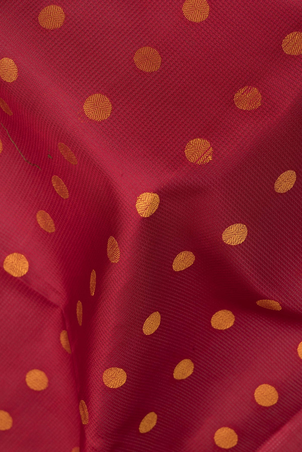 Close up of Pure Silk Maroon Dual Tone Soft Saree with Thread Butta on the body and Thread Border.  displaying folds