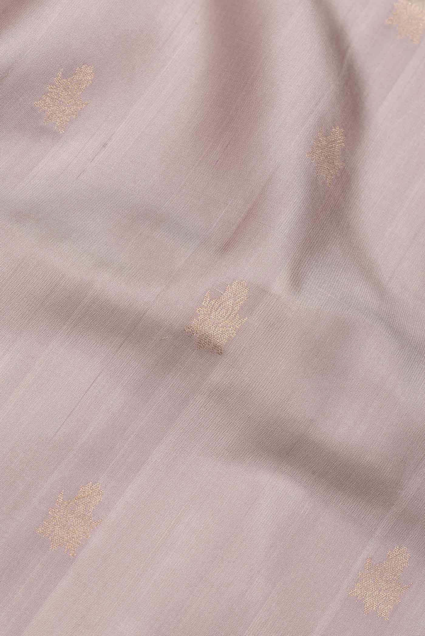 Close up of Dark Beige Dual Tone Soft Silk Saree with Zari Butta on the body and Zari Border.  displaying folds