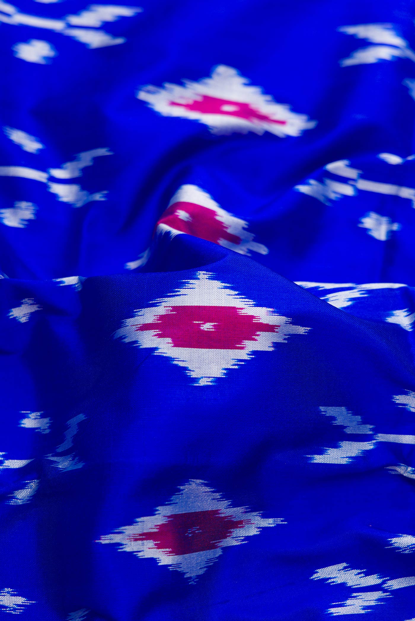 Close up of Royal Blue Dual Tone Double Ikat Saree with Ikat Print on the body and Ikat Border.  displaying folds