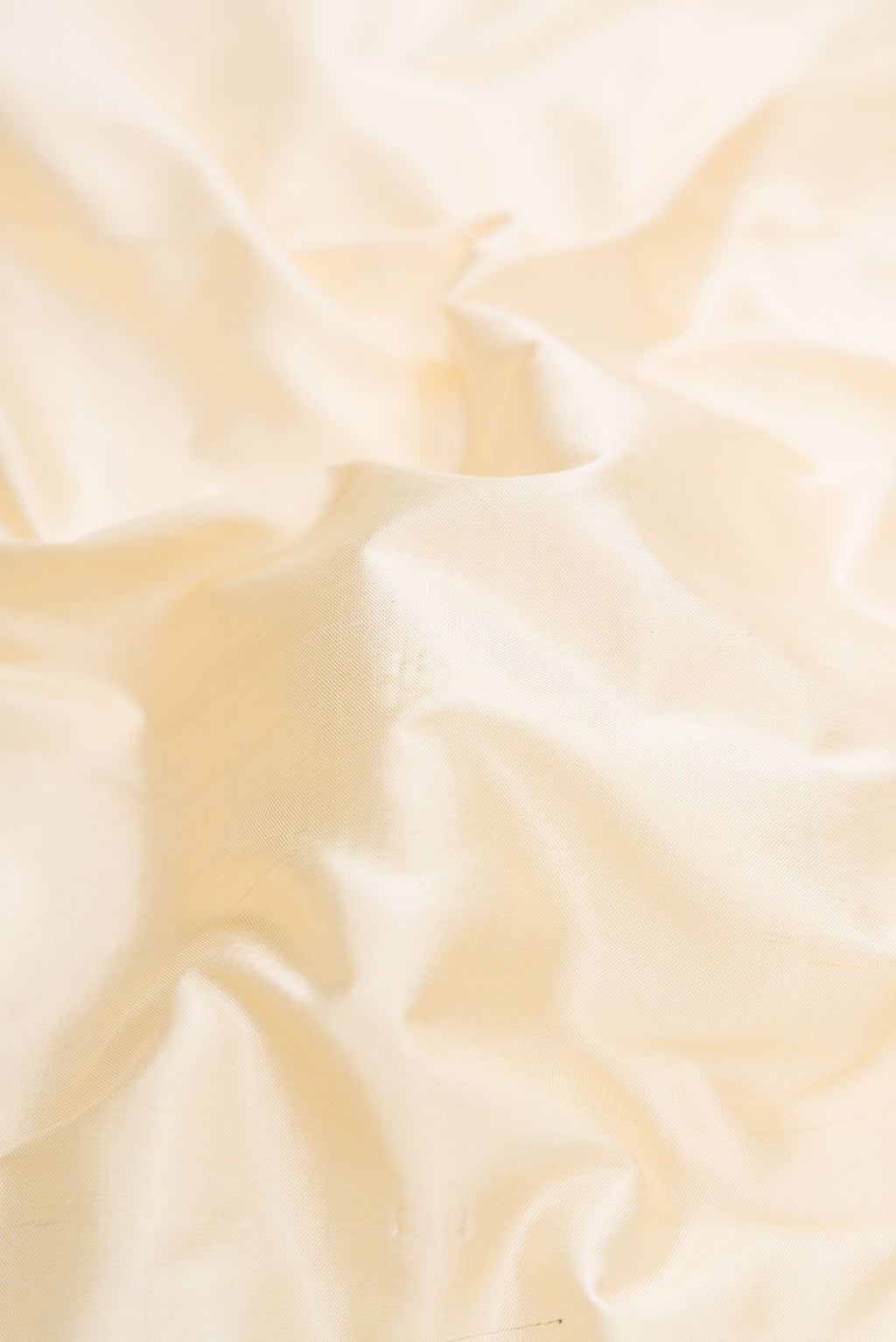 Close up of Beige Dual Tone Double Ikat Saree with Plain Body and Zari Border.  displaying folds