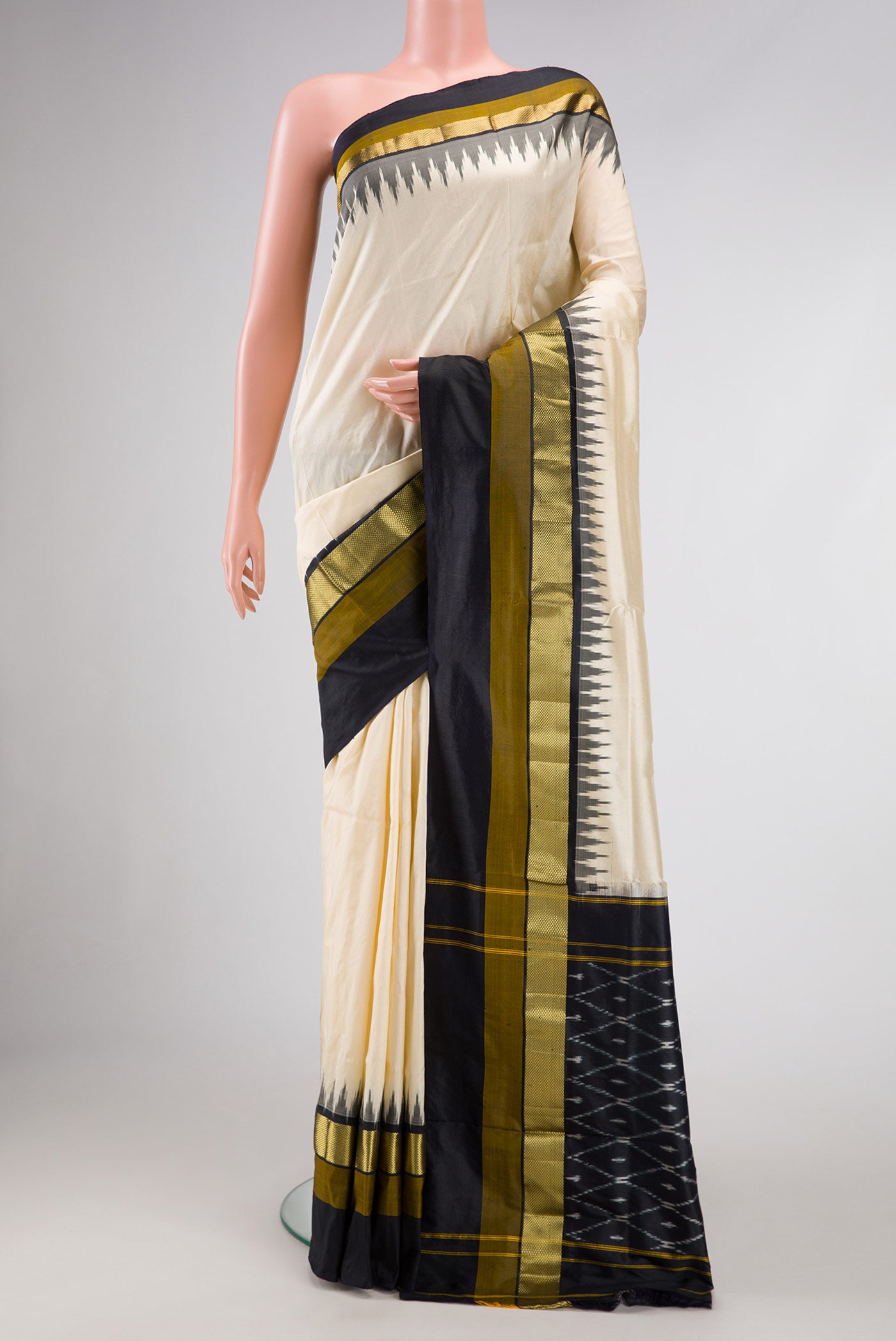 Beige Dual Tone Double Ikat Saree with Plain Body and Zari Border.  displayed on a mannequin
