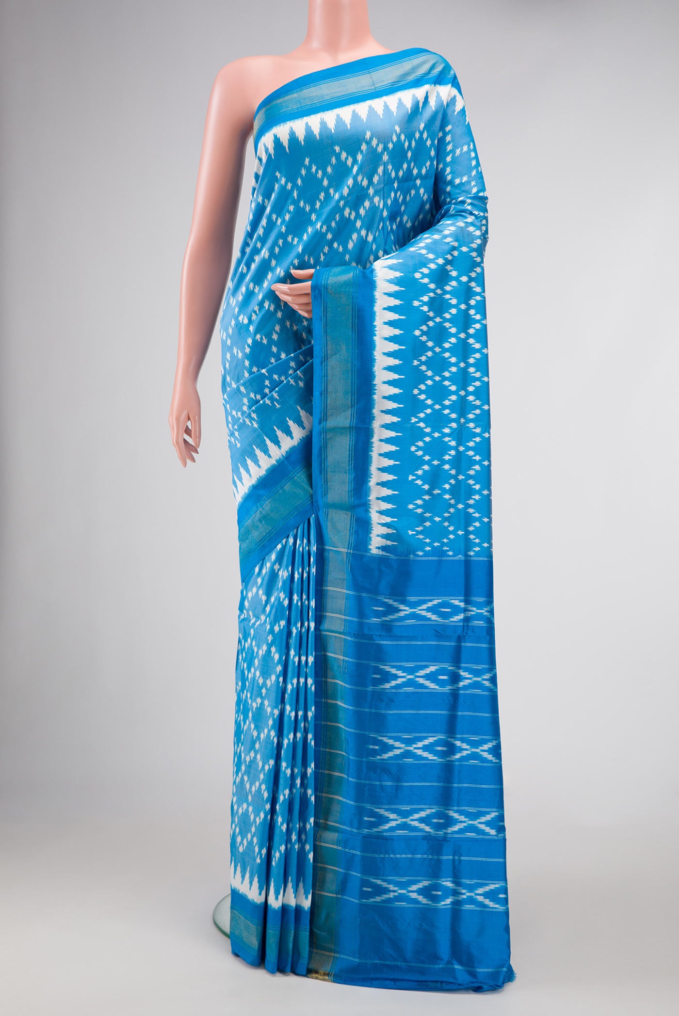 Peacock Blue Dual Tone Double Ikat Saree with Ikat Print on the body and Ikat Border.  displayed on a mannequin