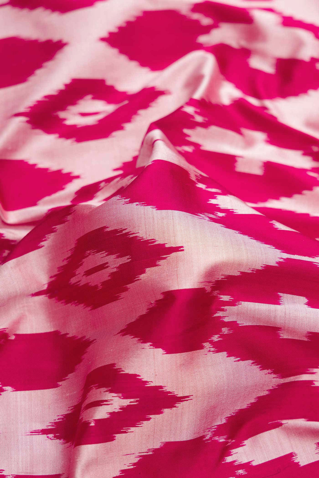Close up of Pink Dual Tone Double Ikat Saree with Ikat Print on the body and Ikat Border.  displaying folds