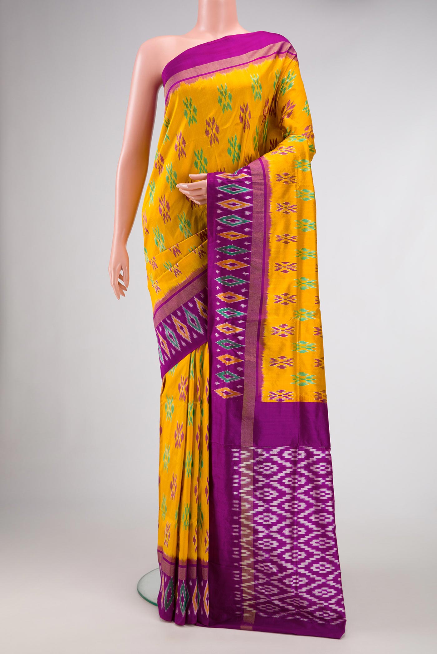 Mustard Dual Tone Double Ikat Saree with Ikat Print on the body and Ikat Border.  displayed on a mannequin