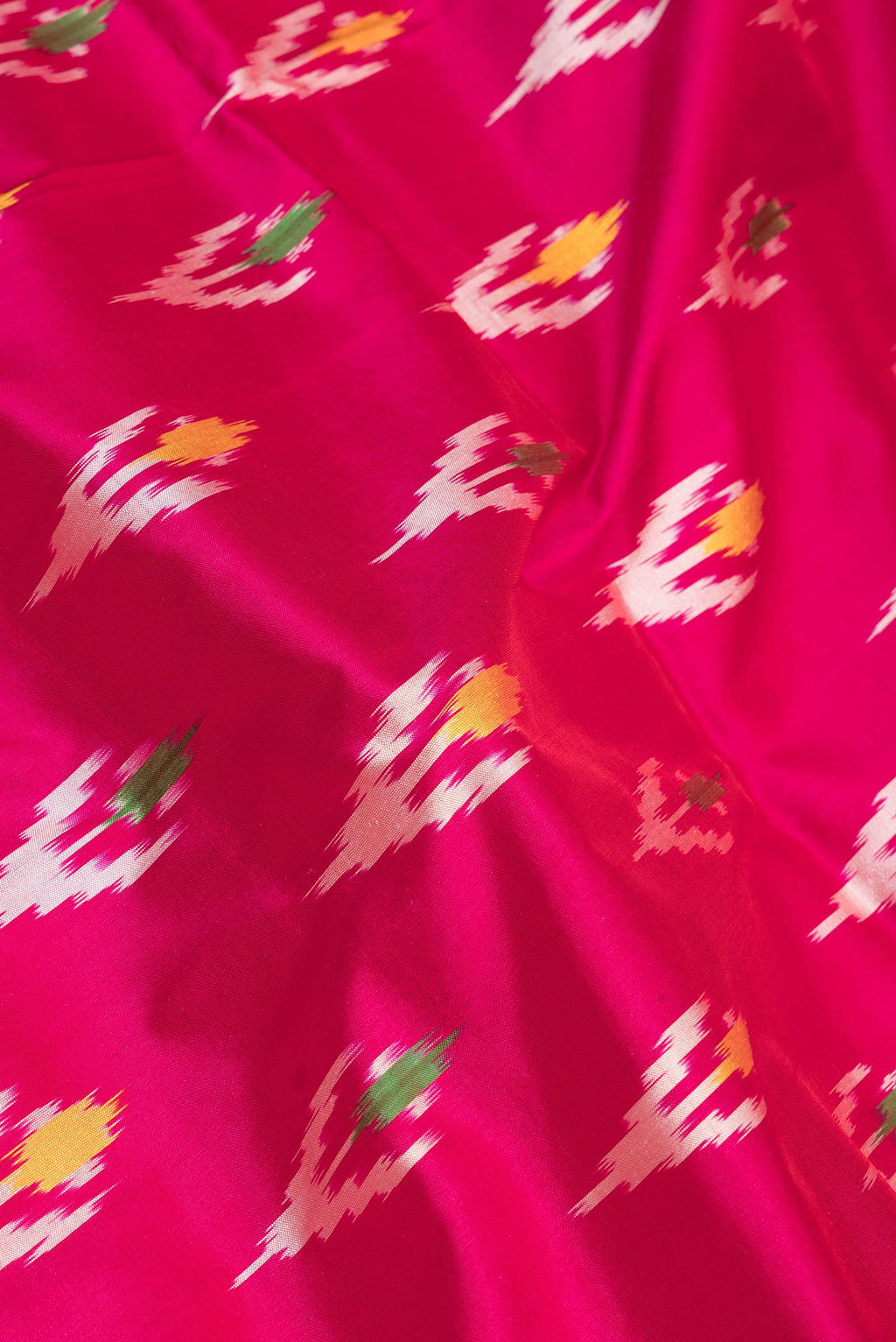Close up of Pure Silk Dark Pink Pochampally Saree with Ikat design on the body and Ikat Border.  displaying folds