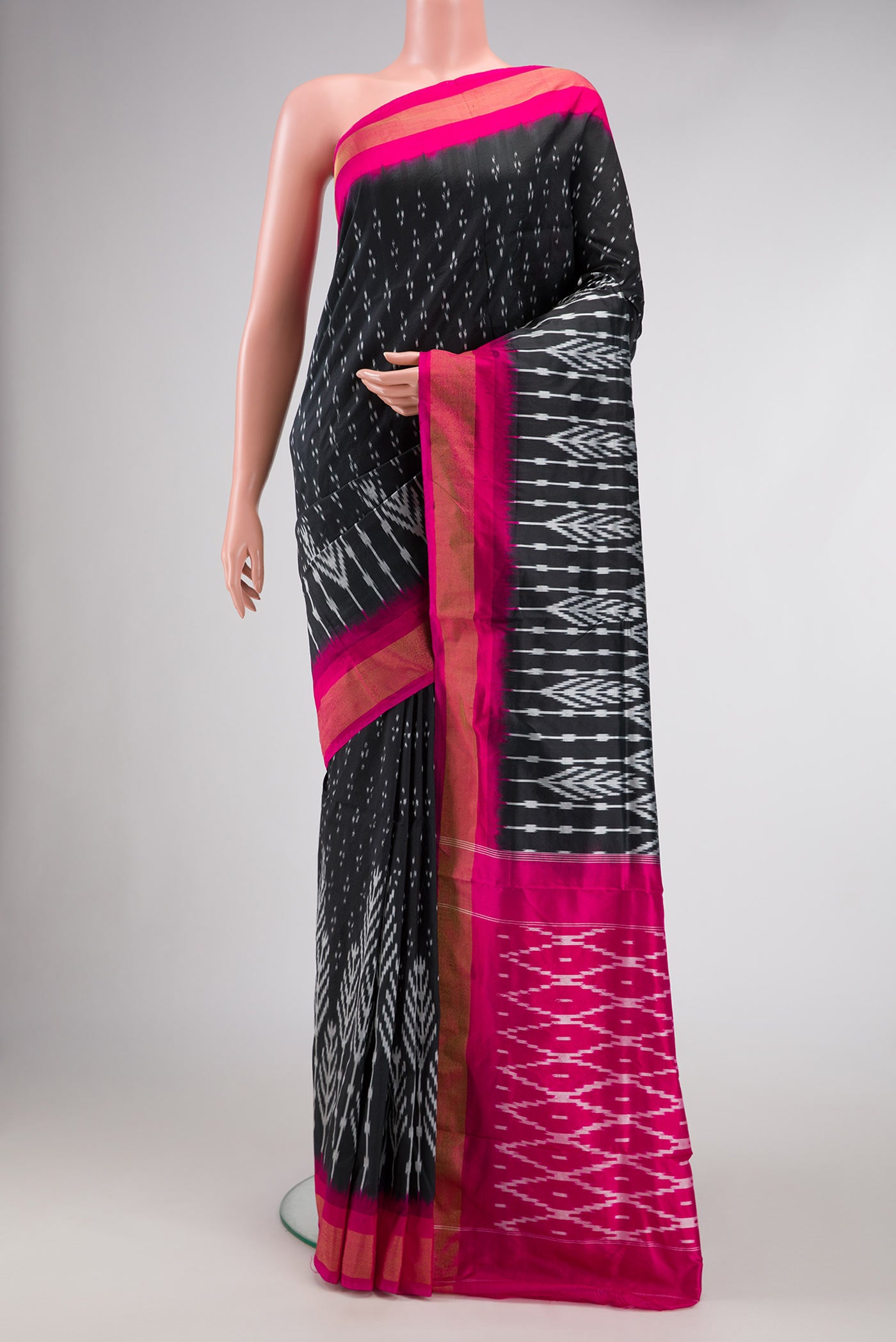 Black Dual Tone Double Ikat Saree with Ikat Print on the body and Ikat Border.  displayed on a mannequin