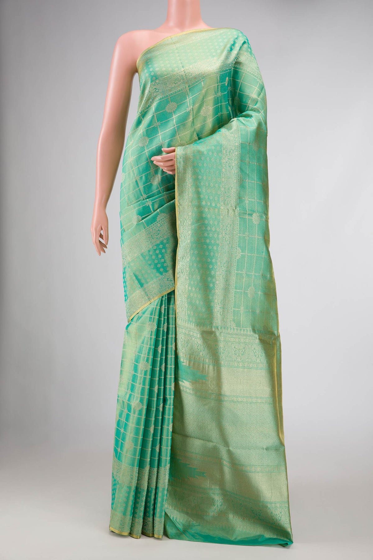 Sea Green Dual Tone Kanjivaram Tissue Silk Saree with Zari Brocade on the body and Zari Border.  displayed on a mannequin
