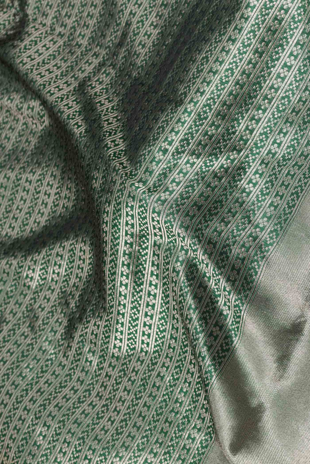 Close up of Green Dual Tone Banarasi Saree with Zari Brocade on the body and Zari Border displaying folds