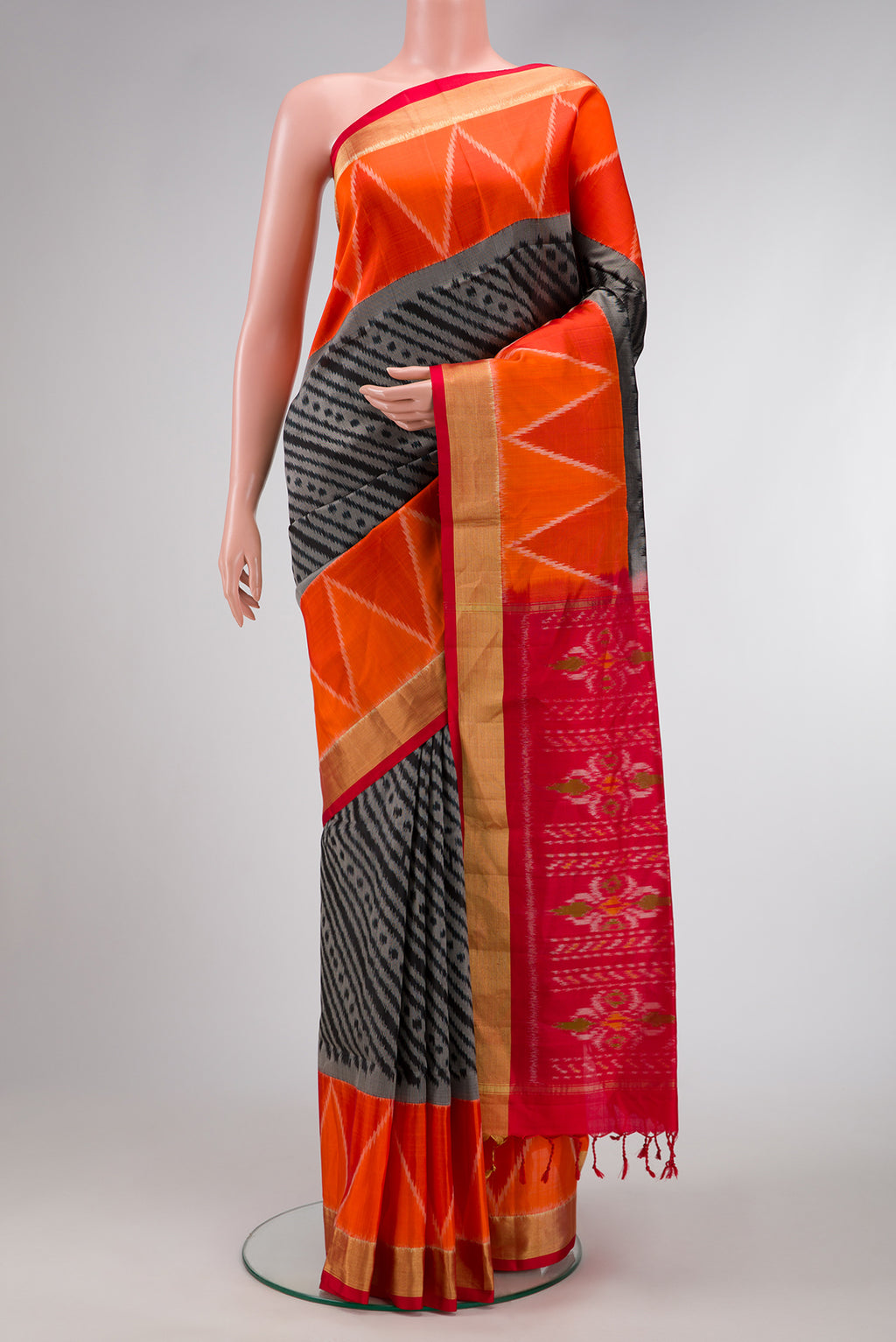 Black Dual Tone Soft Silk Saree with Ikat Print on the body and Ikat Border.  displayed on a mannequin