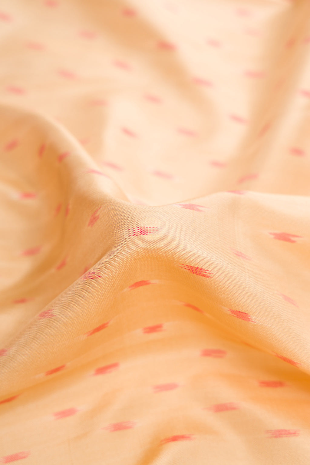 Close up of Sandal Dual Tone Soft Silk Saree with Ikat Print on the body and Ikat Border.  displaying folds