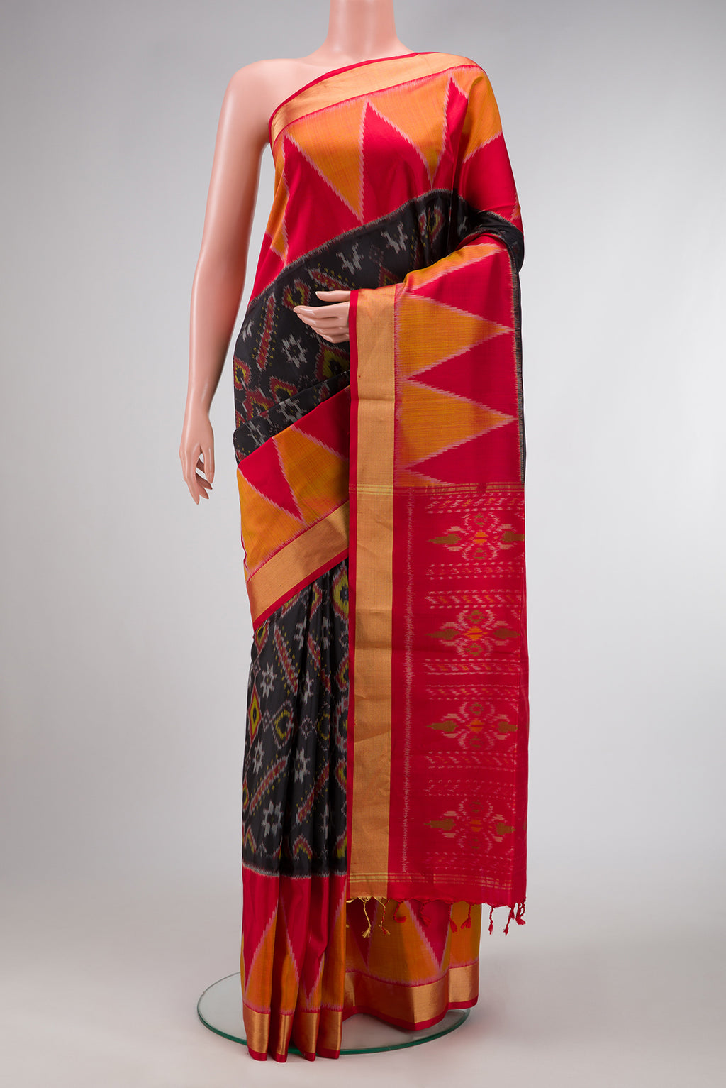 Black Dual Tone Soft Silk Saree with Ikat Print on the body and Ikat Border.  displayed on a mannequin