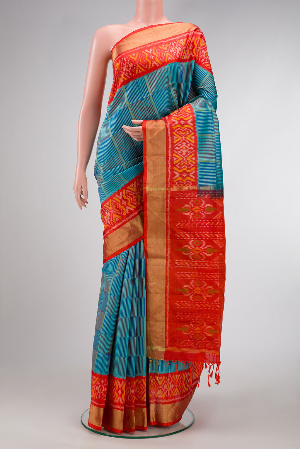 Peacock Blue Dual Tone Soft Silk Saree with Stripes on the body and Ikat Border.  displayed on a mannequin
