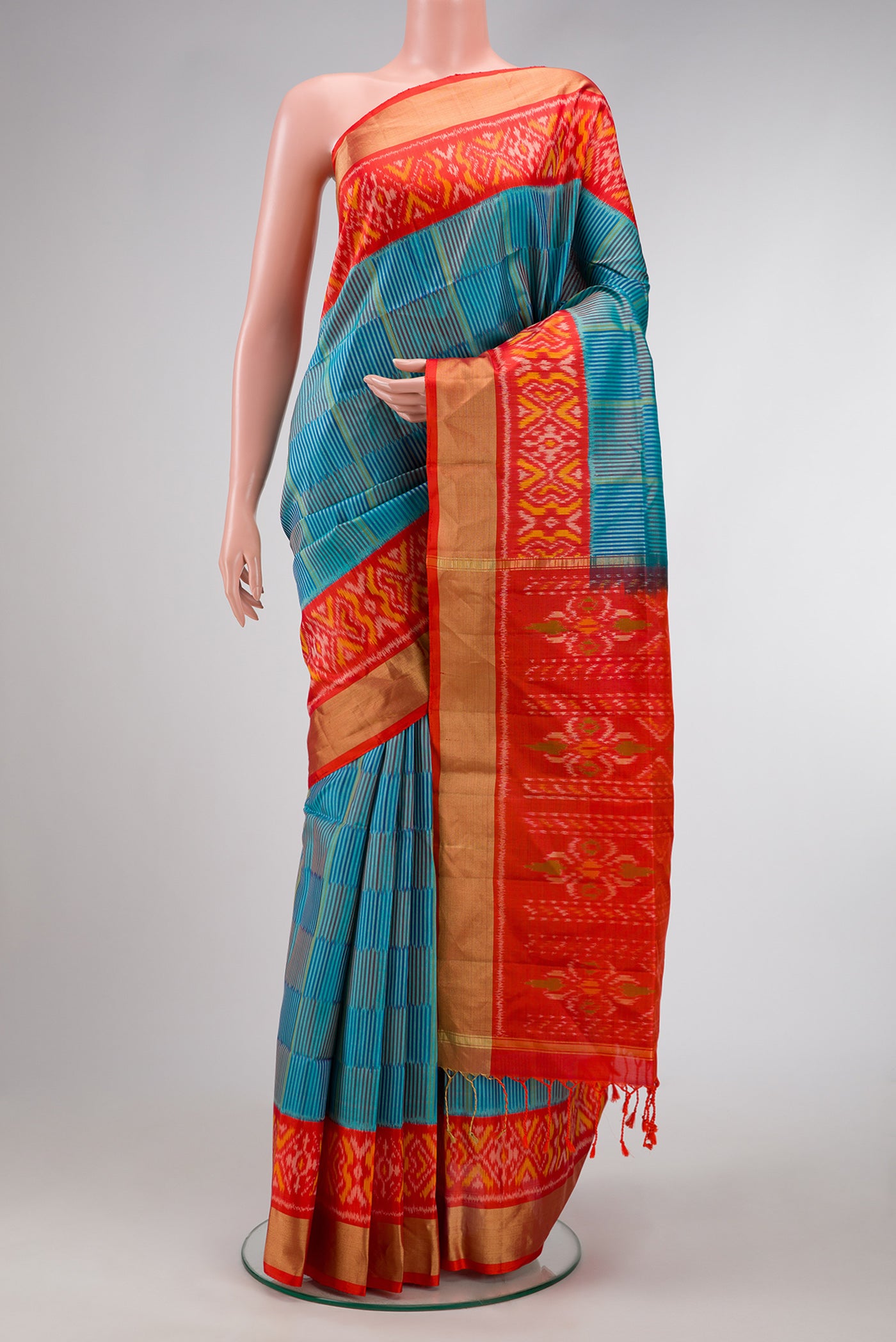 Peacock Blue Dual Tone Soft Silk Saree with Stripes on the body and Ikat Border.  displayed on a mannequin