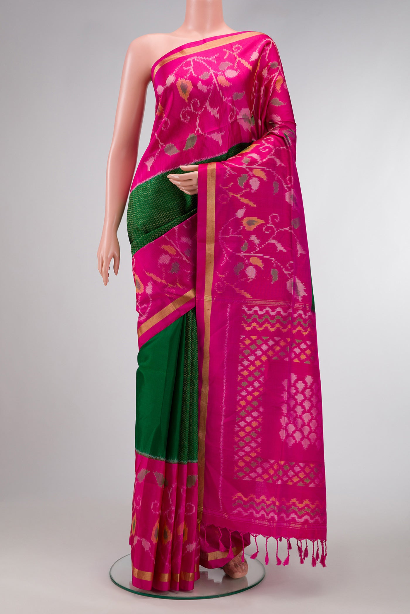 Bottle Green Dual Tone Soft Silk Saree with Zari Brocade on the body and Ikat Border.  displayed on a mannequin