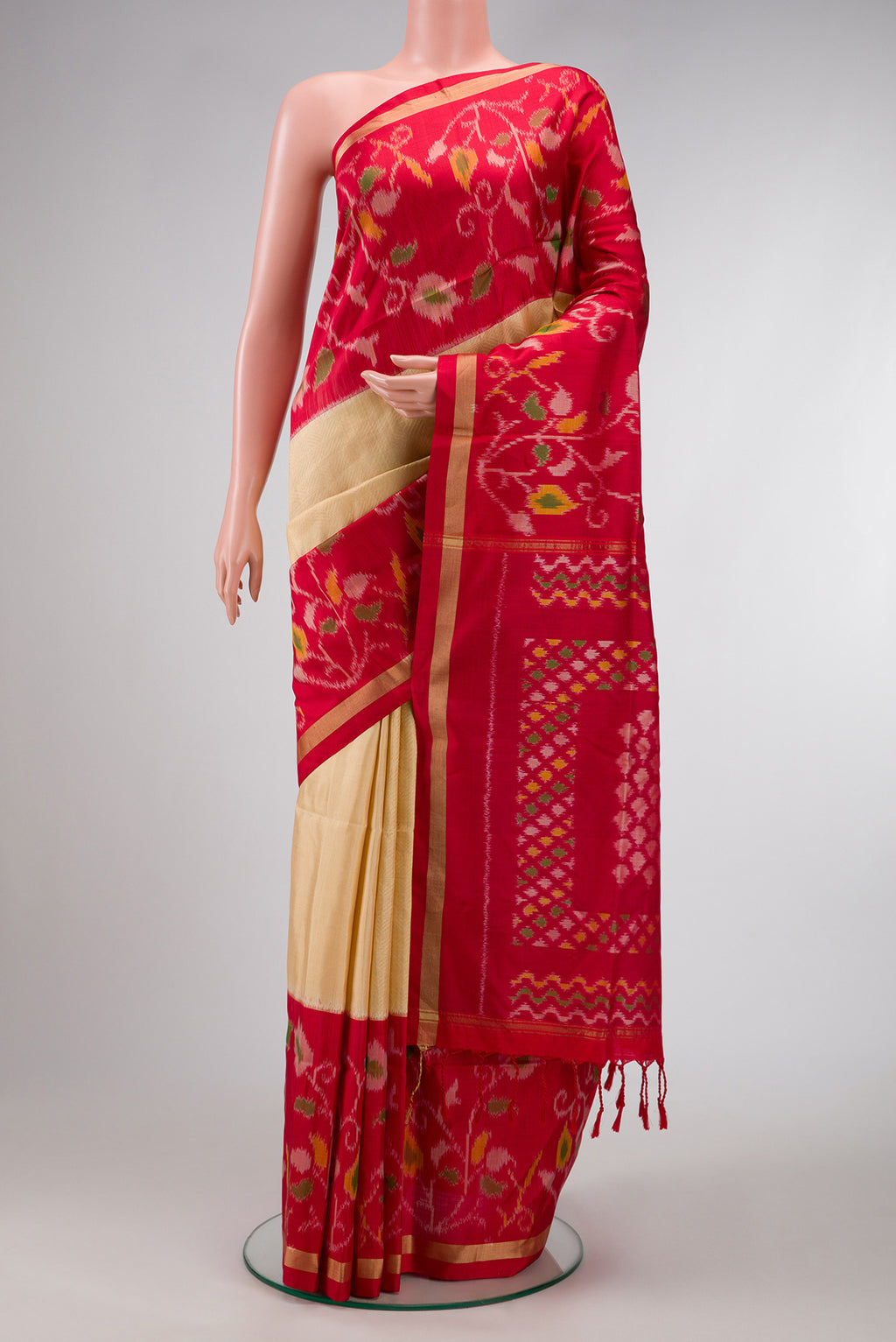 Gold Dual Tone Soft Silk Saree with Zari Brocade on the body and Ikat Border.  displayed on a mannequin