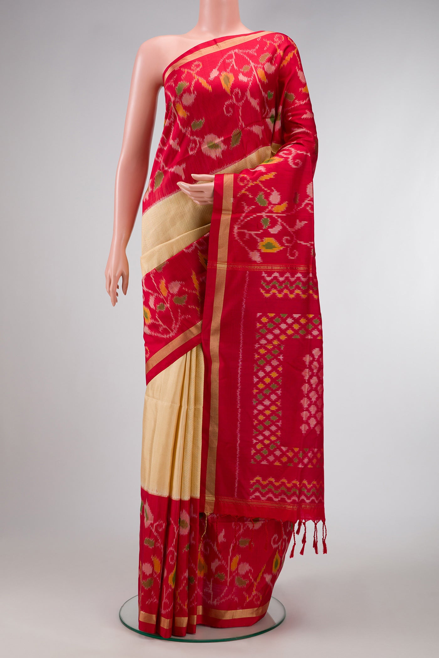 Gold Dual Tone Soft Silk Saree with Zari Brocade on the body and Ikat Border.  displayed on a mannequin