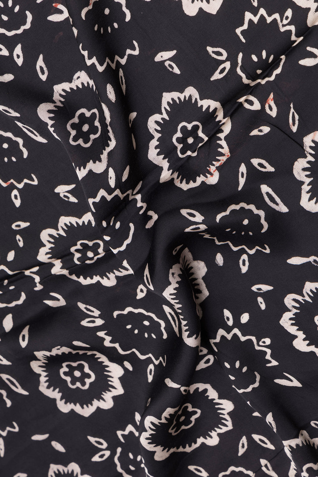 Close up of Black Blended Satin Crepe Saree with Printed design on the body and Printed Border.  displaying folds