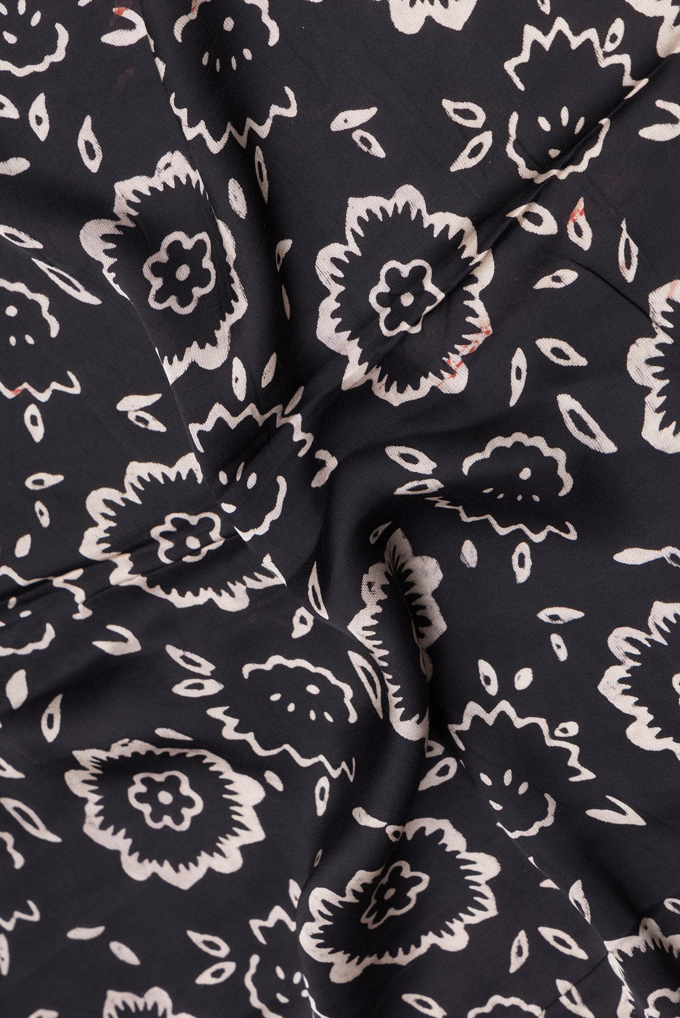 Close up of Black Blended Satin Crepe Saree with Printed design on the body and Printed Border.  displaying folds