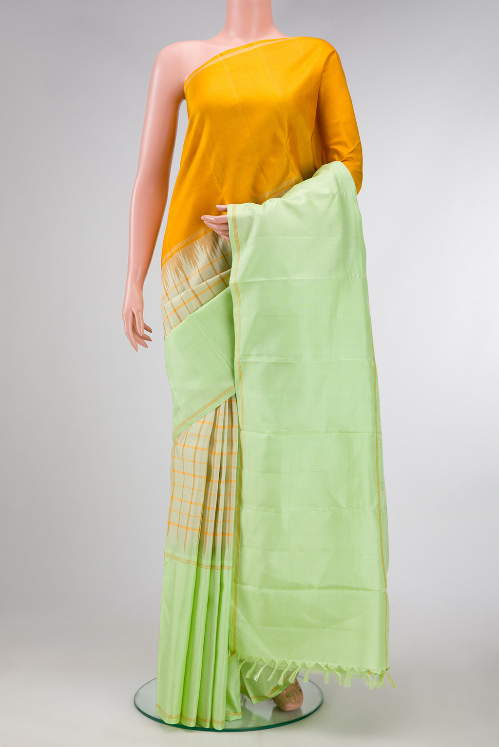 Pista Green Dual Tone Double Ikat Saree with Checked design on the body and Ganga Jamuna Border.  displayed on a mannequin