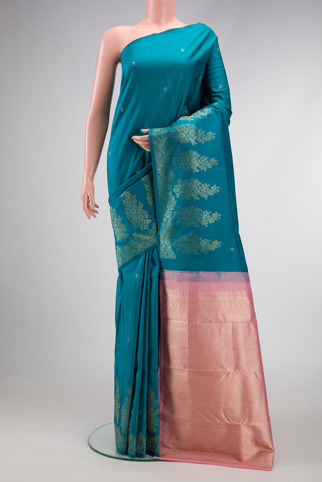 Peacock Blue Dual Tone Kanjivaram Silk Saree with Zari Butta on the body and Fancy Border.  displayed on a mannequin