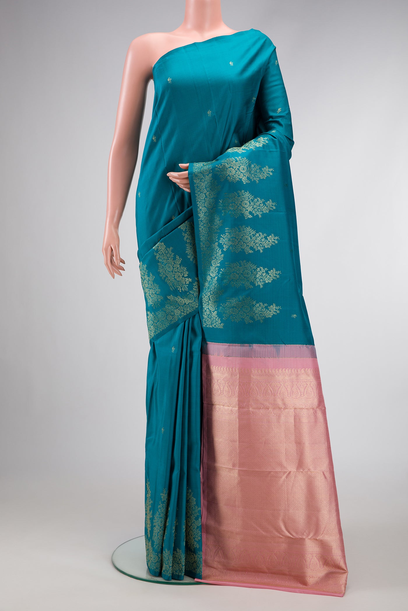 Peacock Blue Dual Tone Kanjivaram Silk Saree with Zari Butta on the body and Fancy Border.  displayed on a mannequin