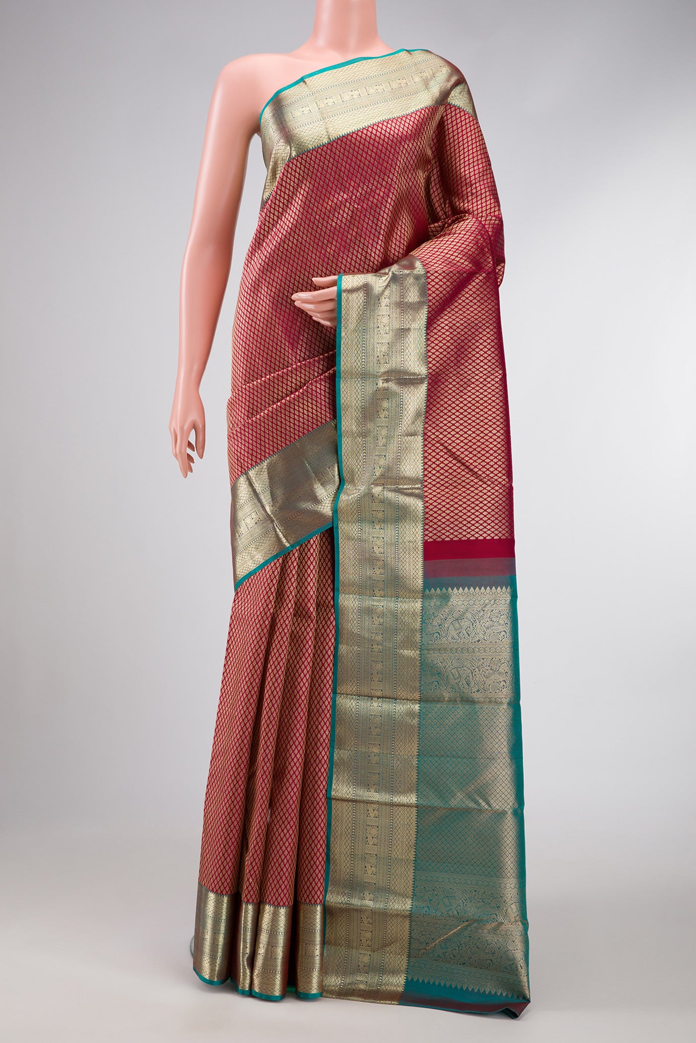 Maroon Dual Tone Kanjivaram Silk Saree with Zari Brocade on the body and Zari Border.  displayed on a mannequin