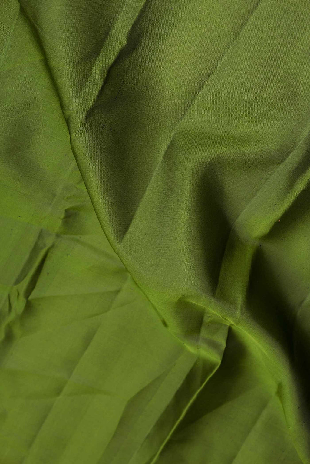 Close up of Mehandi Green Dual Tone Kanchipuram Silk Saree with Plain Body and Zari Border displaying folds