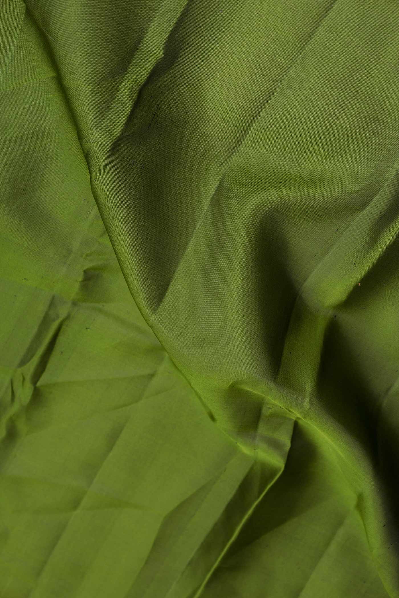 Close up of Mehandi Green Dual Tone Kanchipuram Silk Saree with Plain Body and Zari Border displaying folds