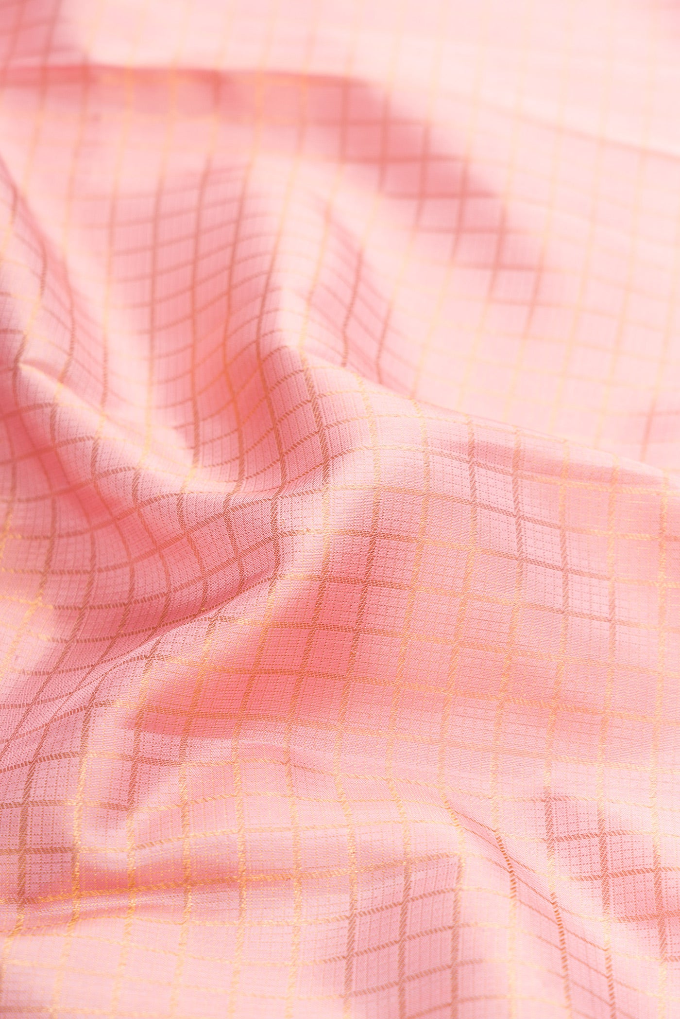 Close up of Pink Dual Tone Kanchipuram Silk Saree with Checked design on the body and Zari Border.  displaying folds