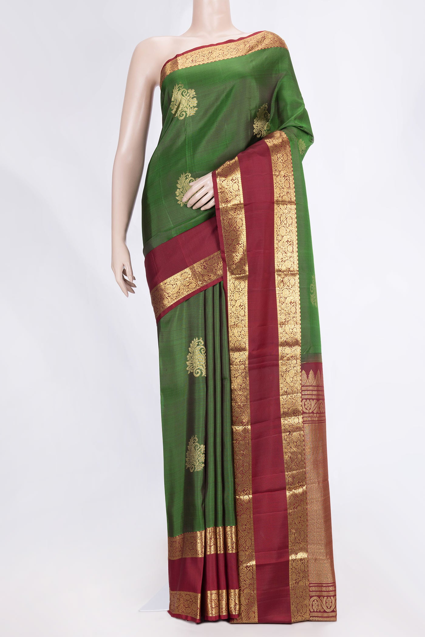 Green Dual Tone Kanchipuram Saree with Zari Butta on the body and Zari Border.  displayed on a mannequin