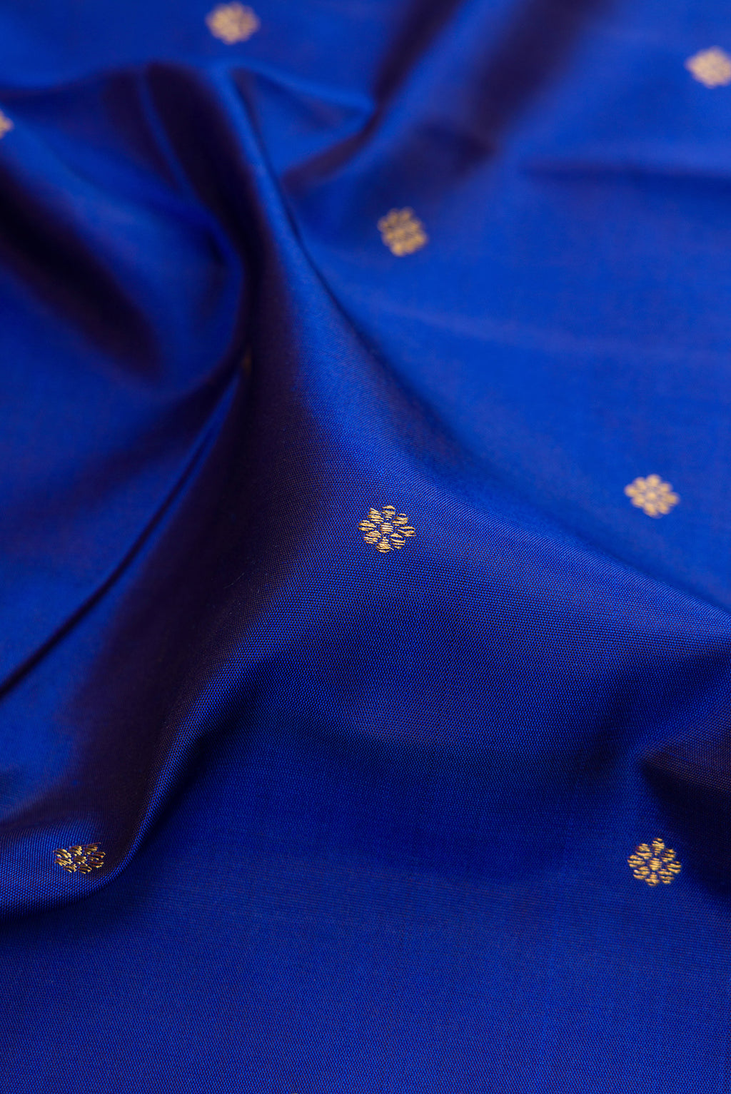 Close up of Pure Silk Pure Zari Royal Blue Kanjivaram Saree with Zari Butta on the body and Fancy Border.  displaying folds