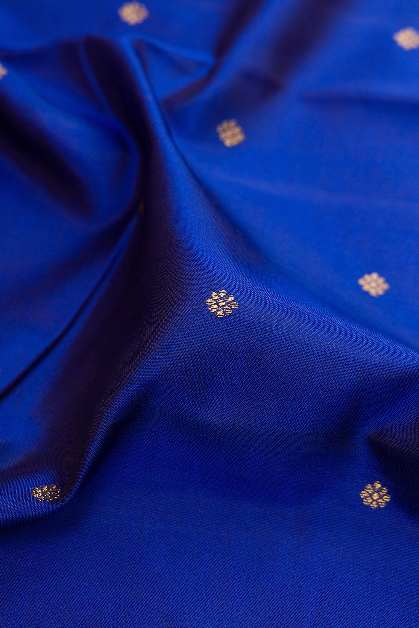 Close up of Pure Silk Pure Zari Royal Blue Kanjivaram Saree with Zari Butta on the body and Fancy Border.  displaying folds