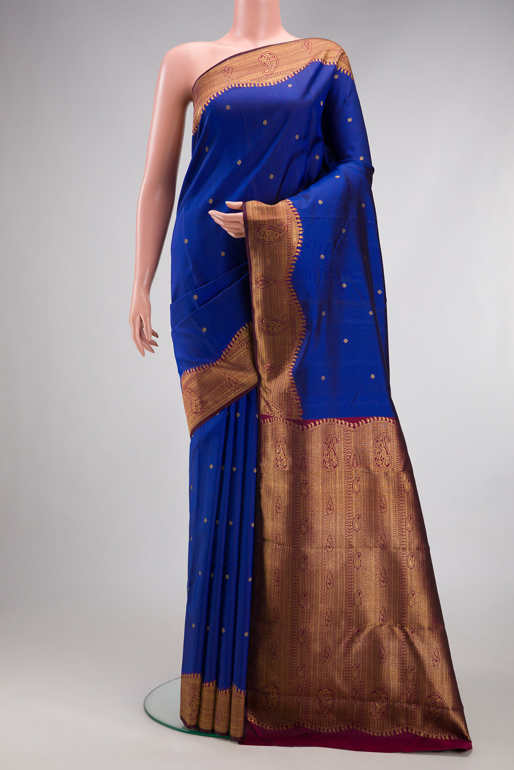 Pure Silk Pure Zari Royal Blue Kanjivaram Saree with Zari Butta on the body and Fancy Border.  displayed on a mannequin