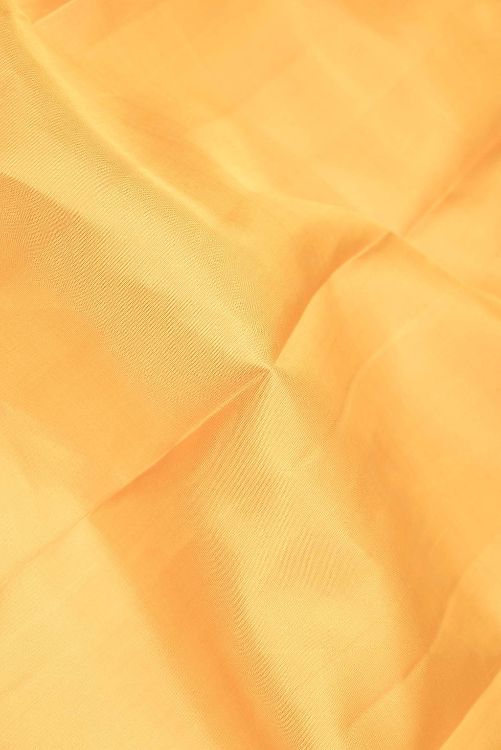 Close up of Pure Silk Pure Zari Mustard Dual Tone Kanchipuram Saree with Plain Body and Zari Border displaying folds