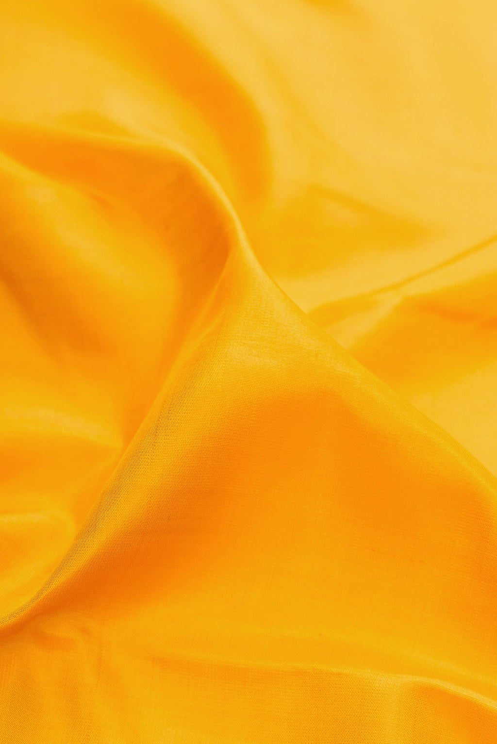 Close up of Pure Silk Pure Zari Yellow Kanjivaram Saree with Plain Body and Fancy Border.  displaying folds