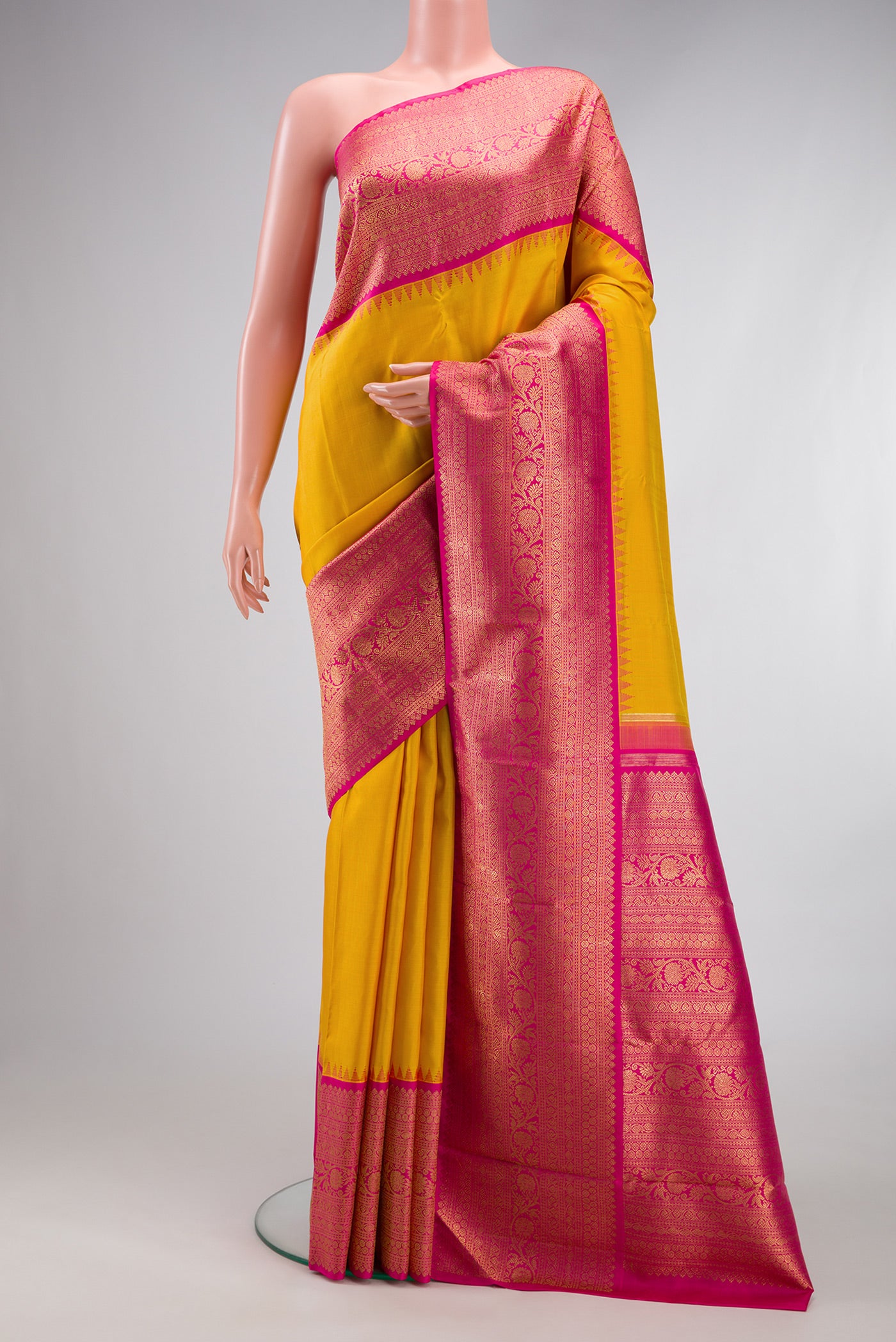 Pure Silk Pure Zari Yellow Kanjivaram Saree with Plain Body and Fancy Border.  displayed on a mannequin