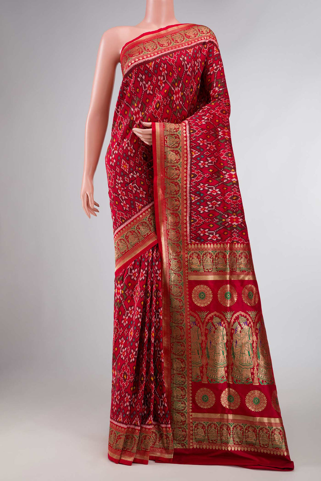 Pure Silk Pure Zari Red Dual Tone Double Ikat Saree with Ikat Print on the body and Fancy Border displayed on a mannequin