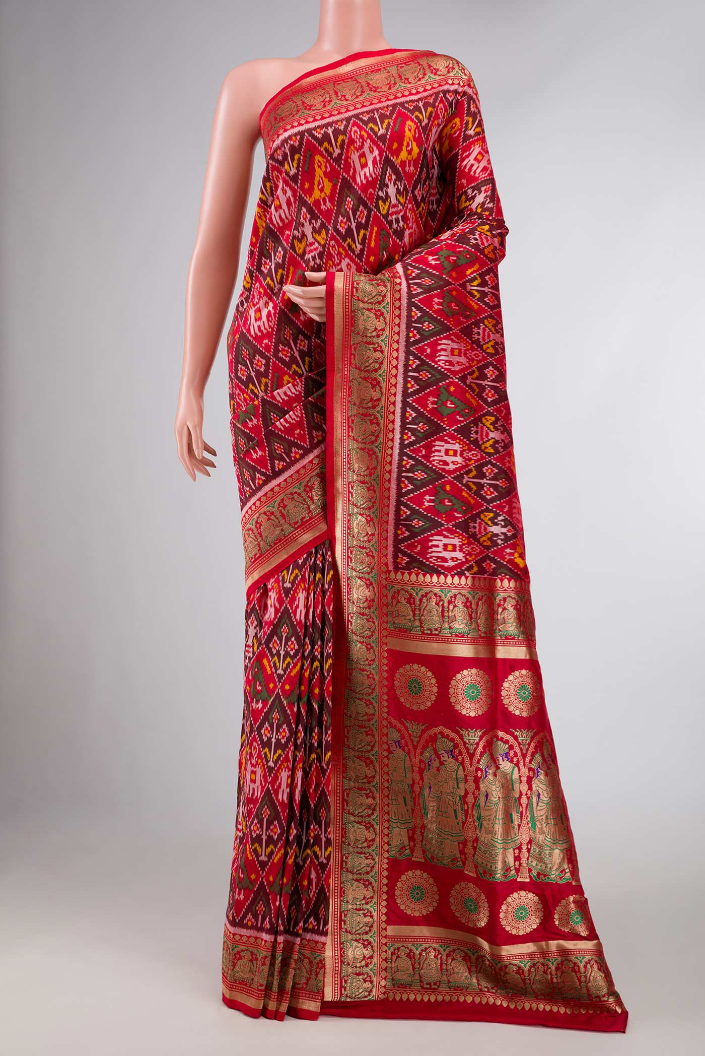 Pure Silk Pure Zari Red Dual Tone Double Ikat Saree with Ikat Print on the body and Fancy Border displayed on a mannequin