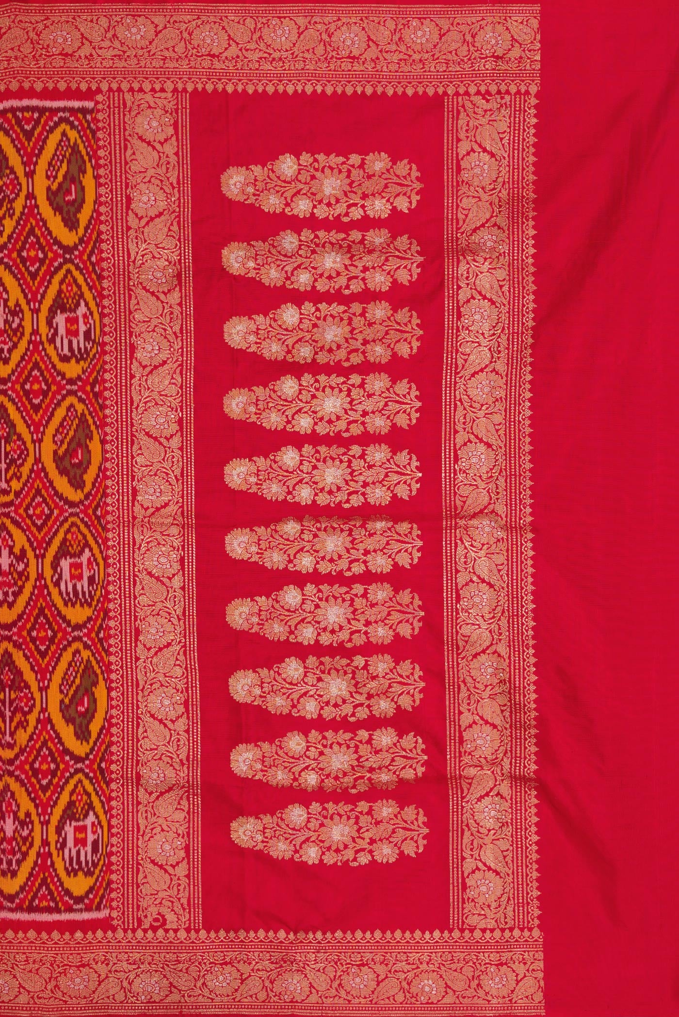Close up image of the pallu of Red Dual Tone Double Ikat Saree with Ikat Print on the body and Zari Border. 