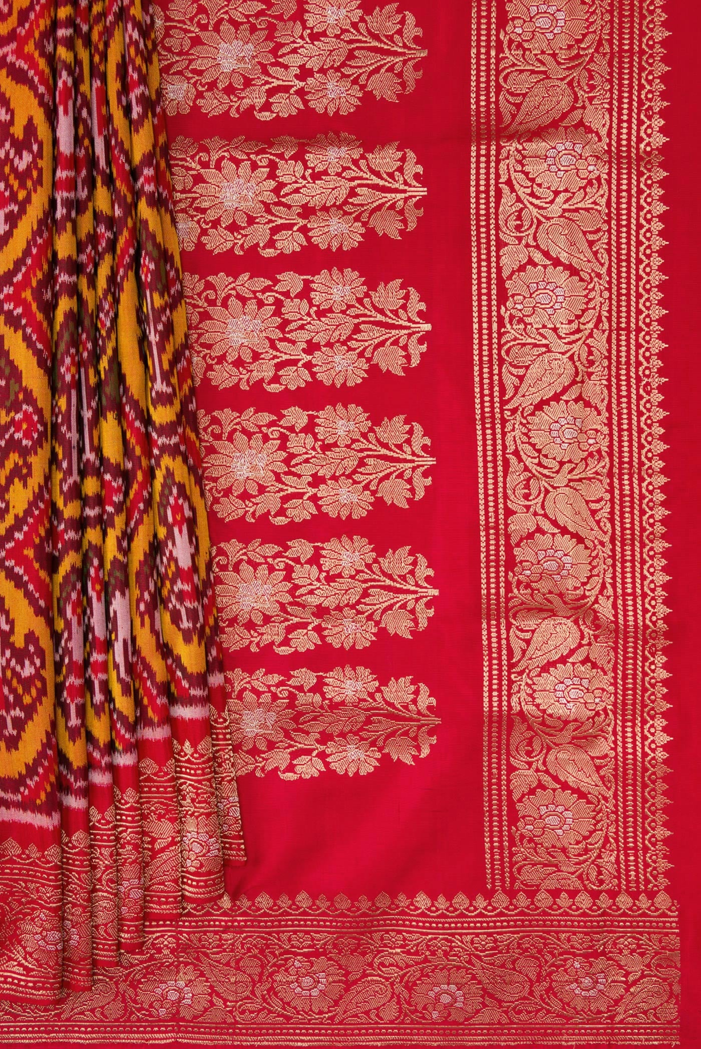 Pleats and pallu of Red Dual Tone Double Ikat Saree with Ikat Print on the body and Zari Border. 